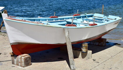 Fototapeta na wymiar Old galician wooden rowboat in a harbor. Galicia, Spain.