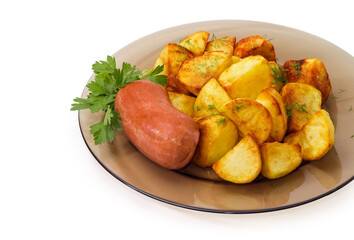 Short thick sausage with fried potatoes on a glass dish