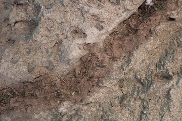 texture of artificial gray brown stone with earth clay