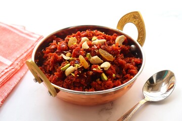 Gajar Halwa. Indian carrot pudding. It's a sweet dessert made from carrots, sugar, and cream. Garnished with cashew, almond, Raisin, and pistachio.