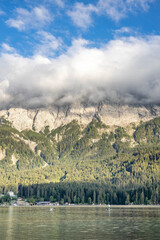 View of Zugspitze in heavy fog by Eibsee Lake in Germany afternoon