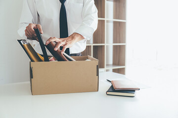 Sad dismissed businessman sitting outside the office after losing his job