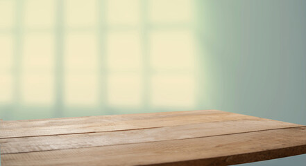 Empty table top made of natural wood, light.rays from the window on the background of the wall. For product demonstration