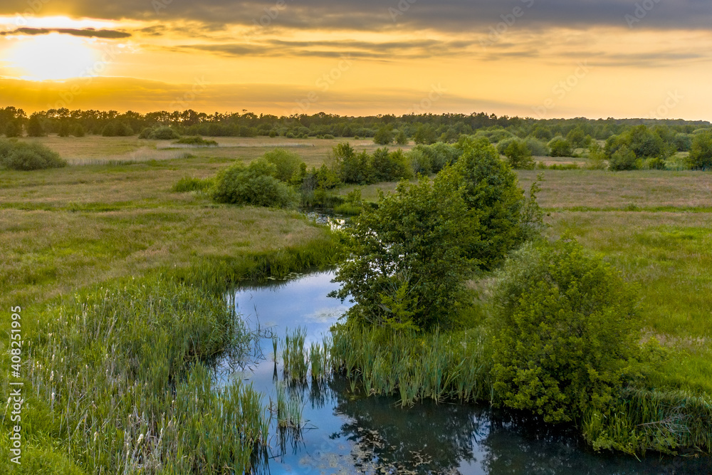 Canvas Prints Aerial view of green grassland river valley