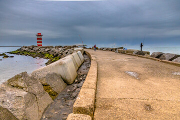 Concrete jetty near IJmuiden with anglers