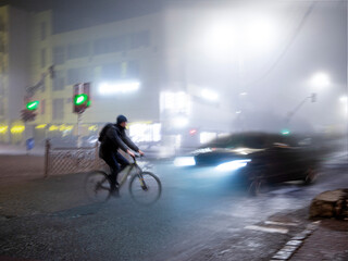 Cyclist on zebra crossing in the evening. Dangerous situation