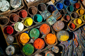 Acrylic paint cans on the table in art workshop