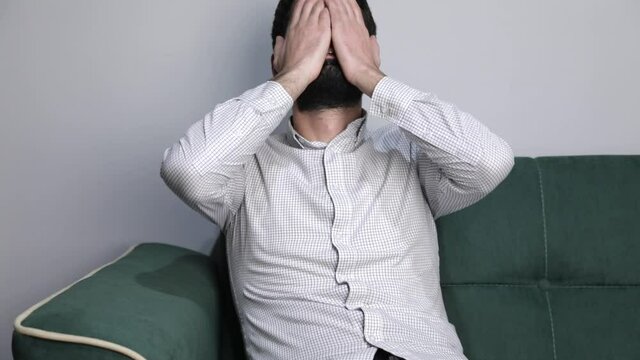 Sad male suffering from headache