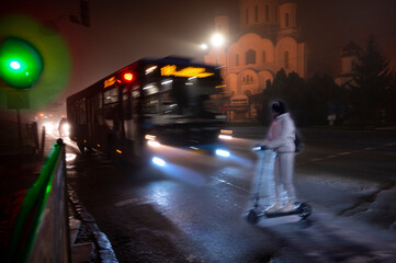Teenager on scooter on zebra crossing in the evening © vbaleha