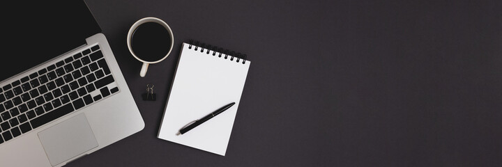Banner with coffee, laptop and office supplies on a black background. Online education, remote job...
