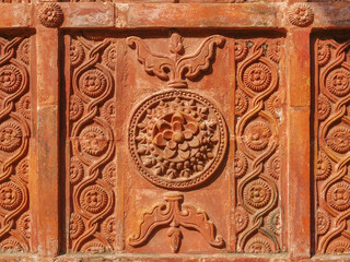Detail of beautiful intricate terracotta carving with floral and geometric pattern on the facade of ancient Atiya or Atia mosque in Tangail district, Bangladesh