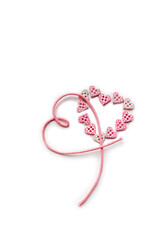 Couple of hearts. Ribbon and button pink hearts with white background and copy space. Tiny heart shape buttons and pink cord. Happy Valentine's Day, Simbol of Love. Top view, close up, vertical.