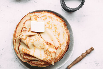 Thin pancakes with butter in a plate