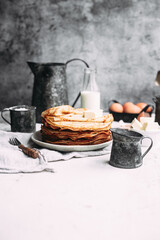 Thin pancakes with butter in a plate