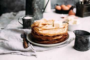 Thin pancakes with butter in a plate