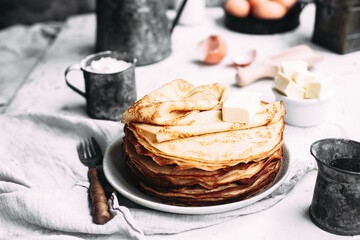 Thin pancakes with butter in a plate