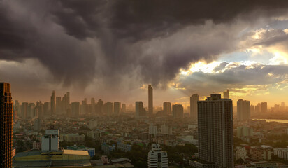 Cityscape with skyscraper building. Morning Sunlight through the sky with gray clouds. Riverfront city with golden sunrise. Urban modern building. Crowded with business and financial center building.