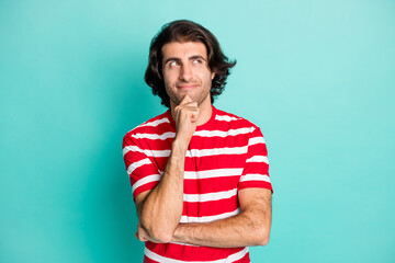 Portrait of nice cheery curious brown-haired guy touching chin thinking copy space isolated over bright green turquoise color background