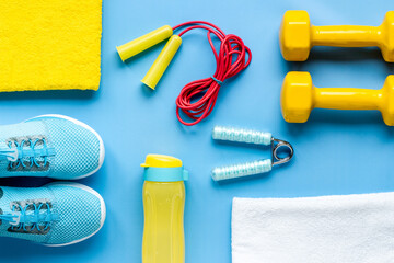 Fitness and gym equipment with sneakers and dumbbells. Sport background