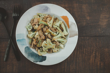 Stir fried cauliflower with oyster sauce recipe and pork on a plate