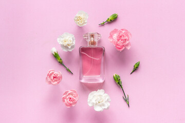 Fragrances perfume bottle with flowers, flat lay, top view