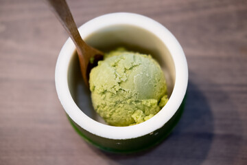 Green tea matcha ice cream scoop in bowl