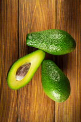 Avocado on vintage wooden table. Raw fruits healthy green food. Avocados banner or diet concept