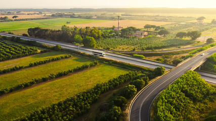 Aerial Drone Shot: Long Haul Semi Truck Driving on the Busy Highway in the Rural Region of Italy....