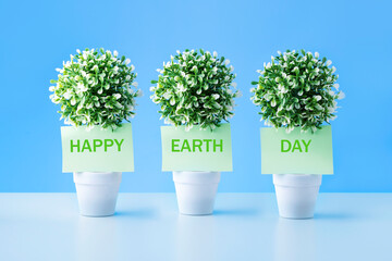 Green notes with words Happy Earth Day. Concept environmental protection.