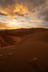 Fototapeta na wymiar Scenic view of Atacama Desert with sandy dunes and rough rocks on sunny day in Chile