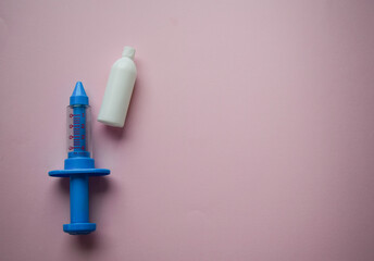 Child medicine tools. Vaccination COVID19. Blue syringe with vaccine on blue background. Concept vaccination children on coronavirus.