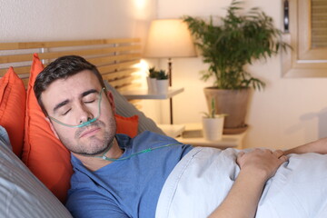 Man using breathing aid in bed