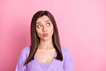 Fototapeta premium Portrait of impressed nice girl blow kiss look empty space wear lilac sweater isolated on pink color background