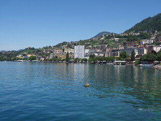 Fototapeta na wymiar Marvelous Lake Geneva and european Montreux city in canton Vaud in Switzerland, clear blue sky in 2017 warm sunny summer day on July.