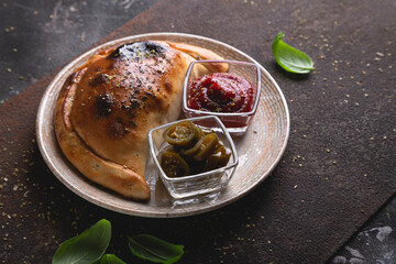 Calzone pizza with sauce and hot pepper