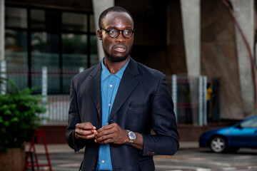 handsome adult businessman standing on the street.