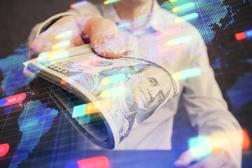 Double exposure of technology drawing hologram and us dollars bills and man hands. Data concept