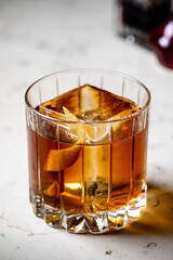 Old fashioned Negroni classic cocktail served on the rocks on counter bar background. Whisky Old Fashioned served on rocks with orange