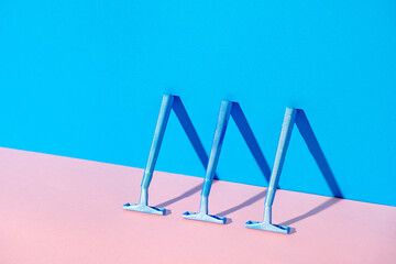 Disposable razor on blue and pink background