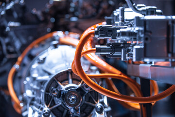 Chassis of the electric car with powertrain and power connections closeup. Blue toned. EV car...