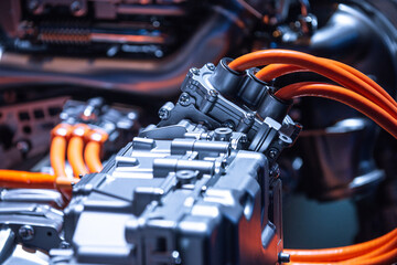 Chassis of the electric car with powertrain and power connections closeup. Blue toned. EV car...
