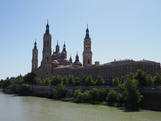 Great basilica of our lady of the Pillar and Ebro river in european Saragossa city at Aragon district in Spain, clear blue sky in 2019 warm sunny summer day on September.