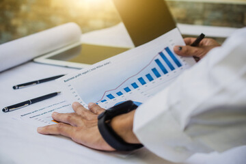 Businessman checking business profit result report in office