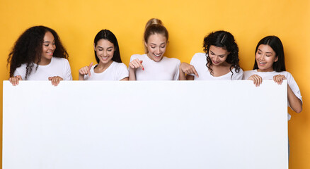 Five Multiethnic Women Holding Blank White Poster, Yellow Studio Background