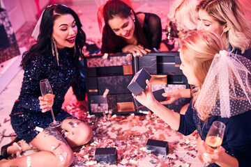 Bride-to-be receiving presents from her friends at the bridal shower