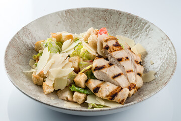 Healthy organic Chicken Caesar Salad with grilled chicken on plate