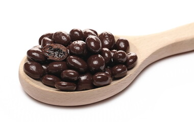 Chocolate coated raisins pile isolated on white background