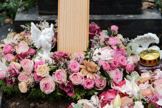 funeral wreath with roses and an angel on a grave after a funeral
