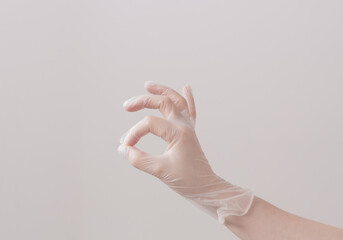 Hand in vinyl glove. Image in pastel colors