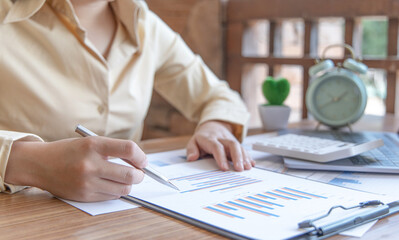 Financial businesswomen analyze the graph of the company's performance to create profits and growth, Market research reports and income statistics, Financial and Accounting concept.